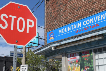 Obraz premium traffic stop and Mountain Convenience signs at Millwood Rd and Mount Pleasant Rd, Toronto