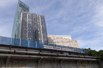 Fototapeta premium looking north and up from outside the Yonge Street underpass of the railway corridor to signage and condo buildings located on The Esplanade, Toronto