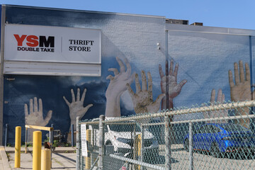 Fototapeta premium building with mural and sign outside YSM's Double Take Thrift Store, a second hand store, located at 310 Gerrard St E, Toronto