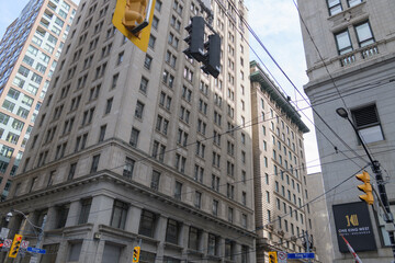 Fototapeta premium wide view of sign outside One King West Hotel & Residence and corner view of Canadian Pacific Railway Building, at 69 Yonge Street / 1 King Street East, Toronto