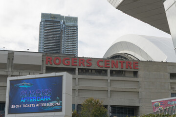 Fototapeta premium east elevation and sign at Rogers Centre, a stadium, with Ripley's Aquarium of Canada sign, Bremner Blvd, Toronto