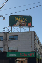 Fototapeta premium traditional rooftop billboard with McDonald's Canada ad for Caesar atop Pizza Nova, a pizza restaurant chain, located here at 645B Mount Pleasant Rd, Toronto