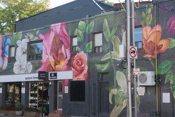 Fototapeta premium exterior large florals mural and sign of apricot flowers, a florist, located at 621A Mount Pleasant Rd, Toronto