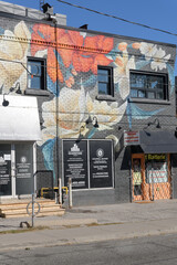 Fototapeta premium exterior building wall with floral mural and location of Riverstone Group Limited, a construction company, located at 693 Mount Pleasant Road, Toronto