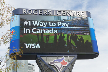 Fototapeta premium Rogers Centre Gardiner Pylon LED sign featuring advertising for VISA, Toronto