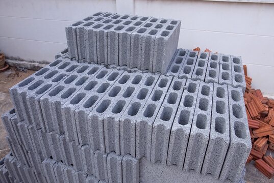 Stacked gray concrete cinder blocks ready for construction work at building site