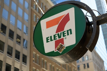 Fototapeta premium round projecting sign of 7-Eleven, a convenience store chain, located here at 372 Bay St, inside Sterling Tower, Toronto