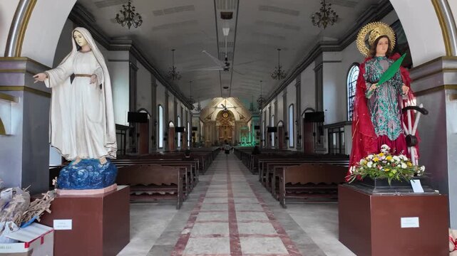 Religious statues flanking cathedral aisle, Dumaguete, Philippines