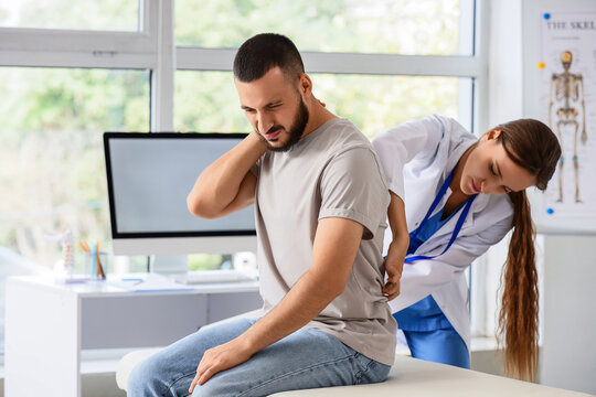 Back pain and physical therapy, doctor examining patient with neck and spine injury in medical clinic for rehabilitation and orthopedic treatment