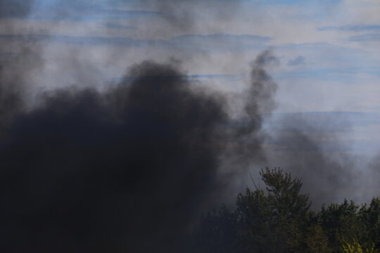 Black smoke billowing in the air