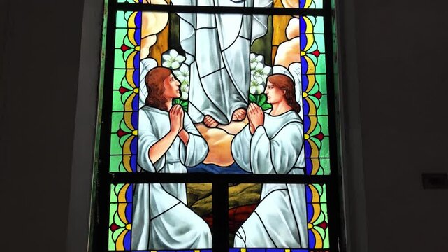 Stained glass window with praying figures and Jesus, Dumaguete, Philippines
