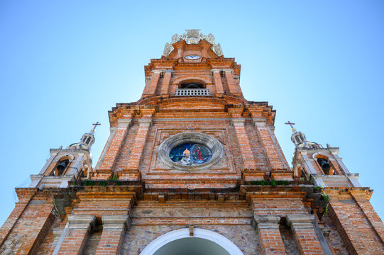 Low angle view of the main tower of the catholic colonial church Our Lady of Guadalupe in Puerto Vallarta, Mexico
