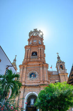 Sunbeams through the steeple of the catholic colonial church Our Lady of Guadalupe in Puerto Vallarta, Mexico