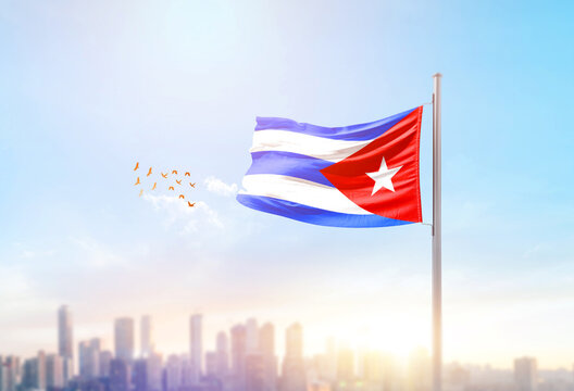 Cuba national flag waving with skyline and buildings.