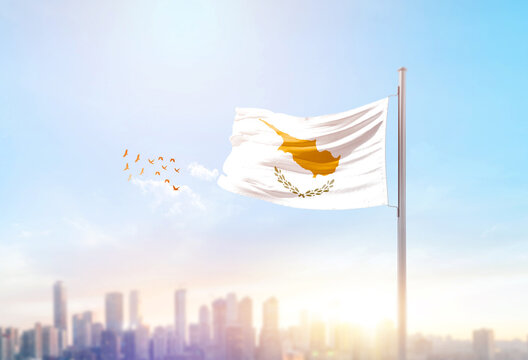 Cyprus national flag waving with skyline and buildings.