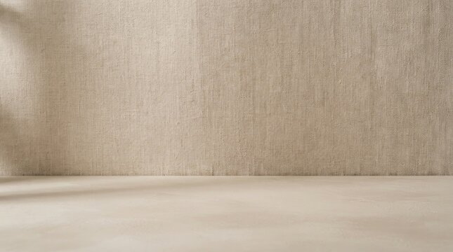 A light beige wall with a textured surface is illuminated by sunlight streaming through a window. The wall is empty, creating a blank canvas.