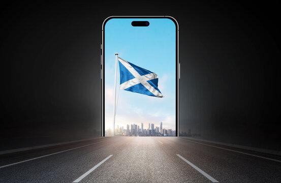 Scotland national flag on phone screen over highway to city. Scotland flag for Republic Day and Independence Day.