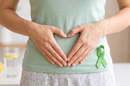 Coeliac Disease Awareness - Person Hands Forming Heart and Green Ribbon