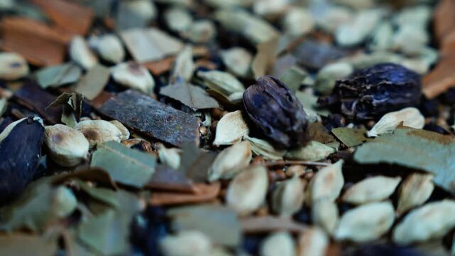 Close up of dried spices and botanicals, Macro view of assorted dried spices, seed pods, bark and leaves in earthy natural colors, with shallow focus and a rustic organic feel.