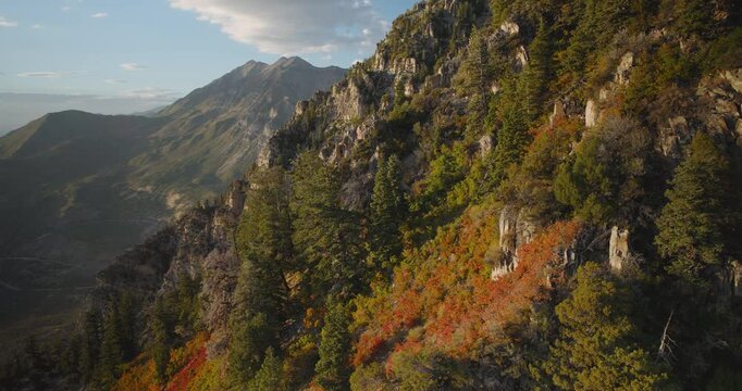 Orange Sunset Glow On Autumn Colored Rocky Mountains - Cinematic Aerial Shot