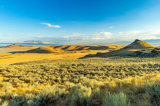 Golden sunrise illuminates rugged landscape along Antelope Island Frary Peak trail