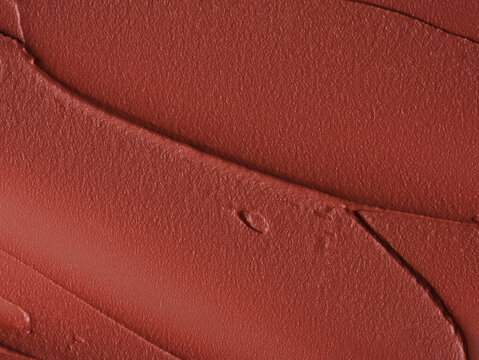 Red lip tint cream texture with curved swatch close up