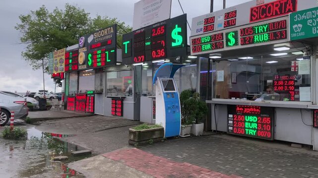 Currency exchange boards showing rates in street view at outdoor forex kiosks in Batumi, Georgia, with USD, EUR, TRY and RUB prices for banking, money, finance