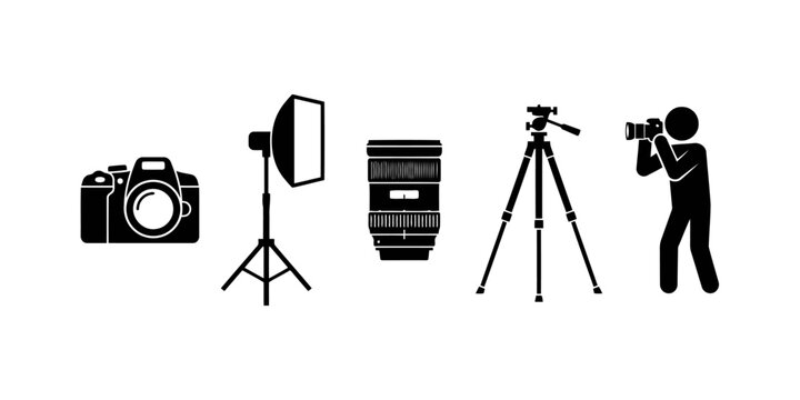 Photographer using dslr camera with tripod and studio light