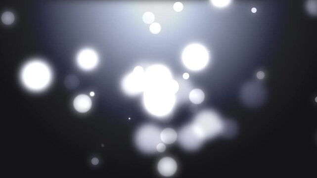 Abstract white glowing floating bokeh particles on dark background cinematic soft light motion background footage