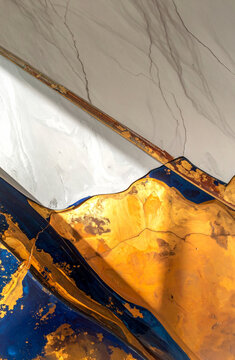 Abstract background featuring white marble, deep blue resin and golden textures with metallic accents. Ideal for luxury branding, interior design projects, packaging, digital content and modern advert