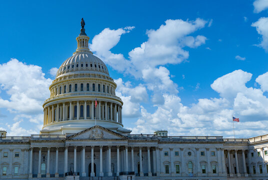 American flag near congress for Flags Day. American flag waving for independence day. Flag waving above American Capitol building. Flag of America in Washington, USA.
