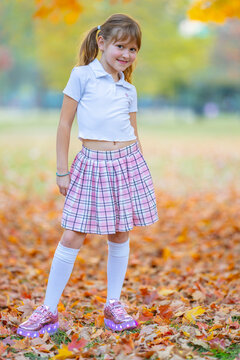 Skirt with casual jacket. Skirt on little girl. Stylish skirt in outdoor portrait. Cute skirt with autumn leaves.