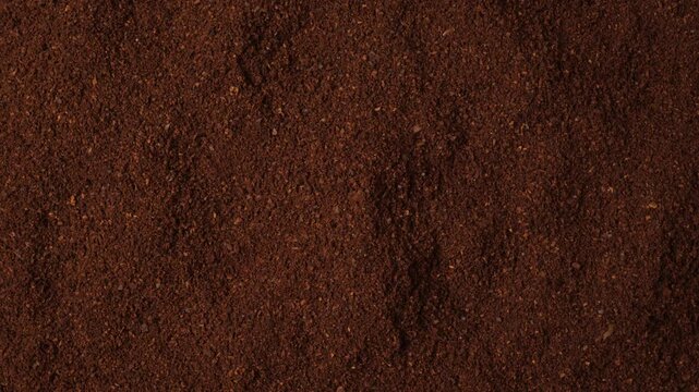 Rotating background of ground roasted coffee