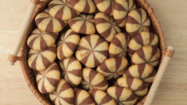 Basket of fresh chocolate vanilla cookies rotating