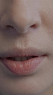 Close-up of female mouth while nervous anonymous woman biting and pursing lips feeling insecure and hurt. People and negative emotion concept.