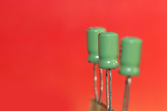 Green ceramic capacitors on red background