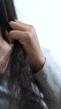 woman sticking brushing her hair falling out and have many hair loss on the comb. problem of Damaged and frizzy. Healthcare and medical concept.	