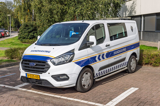 Purmerend, Netherlands - 27 September 2026 - A white patrol van of the Handhaving local law enforcement parked on a brick street in the city of Purmerend.