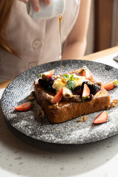 Breakfast toast with honey and fruit for brunch celebration in a