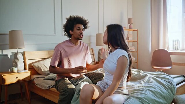 Multiracial couple arguing bedroom. Woman rejecting boyfriend explanations home.