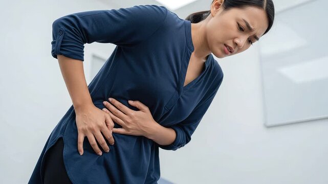 Woman Suffering From Abdominal Pain And Stomachache In Medical Clinic