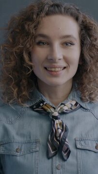 Portrait of excited young lady expressing joy feeling happy looking at camera on black studio background. Positive emotion and people concept.