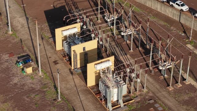Electrical substation with power transformers, high voltage switchgear, busbars, insulators and transmission structures, Posadas, Misiones, Argentina, drone aerial shot
