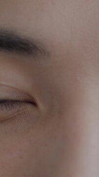 Close-up portrait of male eyes looking at camera with no emotion. Human body part and face expression concept.
