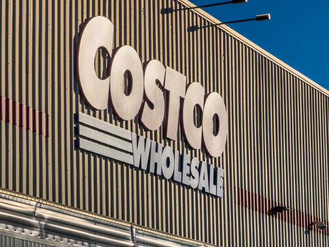 Calgary, AB, Canada. September 29, 2026. Low angle view of the Costco Wholesale exterior corporate sign on a corrugated metal warehouse wall.