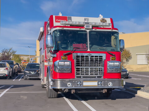 Calgary, AB, Canada. September 29, 2026. Front view of a red Calgary fire department rescue truck parked in a sunny outdoor lot.