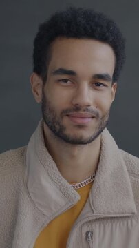 Portrait of African American man shaking head rejecting offer looking at camera on black studio background. People and face expression concept.