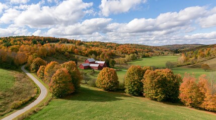 Obraz premium The Red Barn Surrounded by Autumn Foliage and Rolling Meadows
