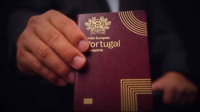Portuguese Passport Held In Hand Close Up