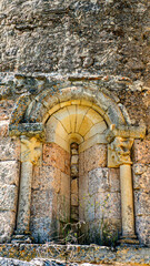 Romanesque glouton capital swallowing shaft beneath corbels at San Julian y Santa Basilisa Church, Rebolledo de la Torre, Burgos, Castilla y Leon, Spain © Nandi Estévez